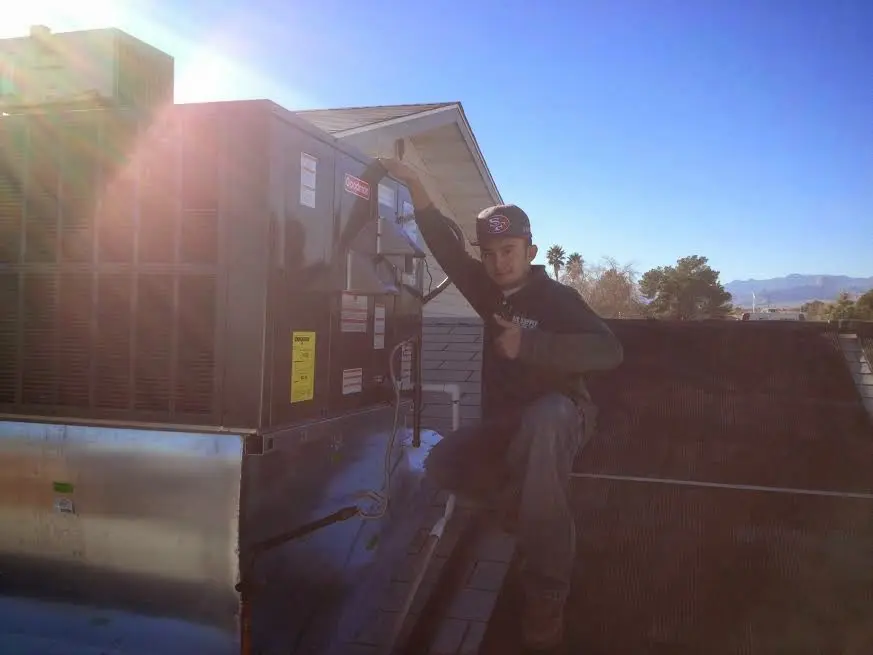 HVAC technician performing HVAC Inspection on a rooftop unit in Lake Ridge